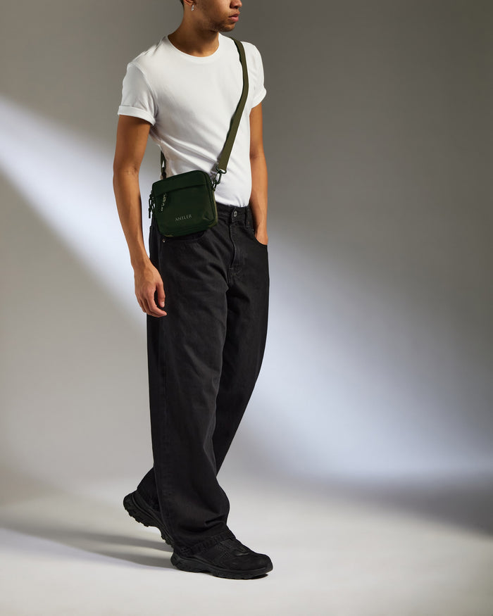 a man in a white shirt and black pants