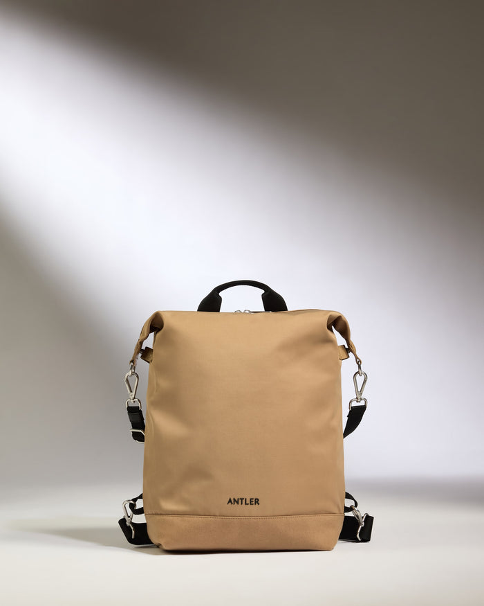 a tan backpack with black straps