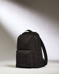 a black backpack on a white surface