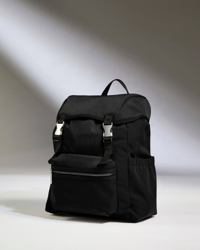 a black backpack with a light shining on it