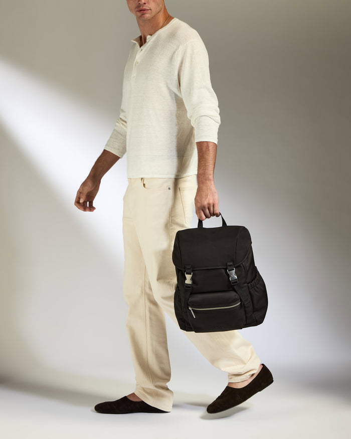 a man walking with a backpack