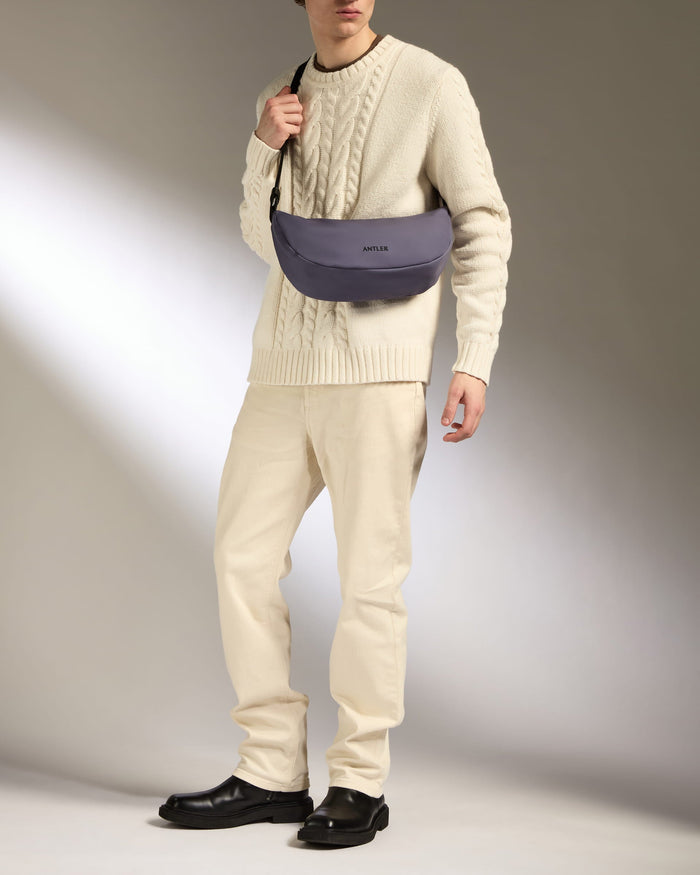 a man in a white sweater and pants