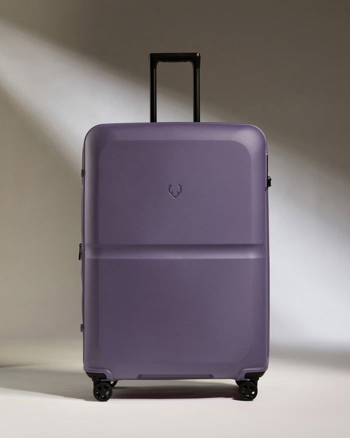 a purple suitcase with wheels