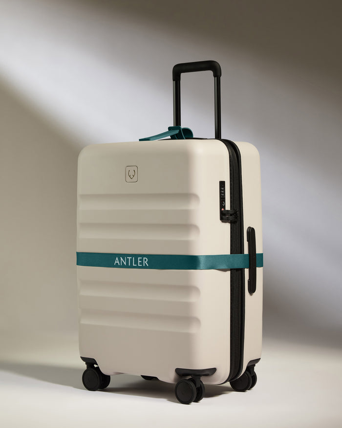 a white suitcase with a blue band