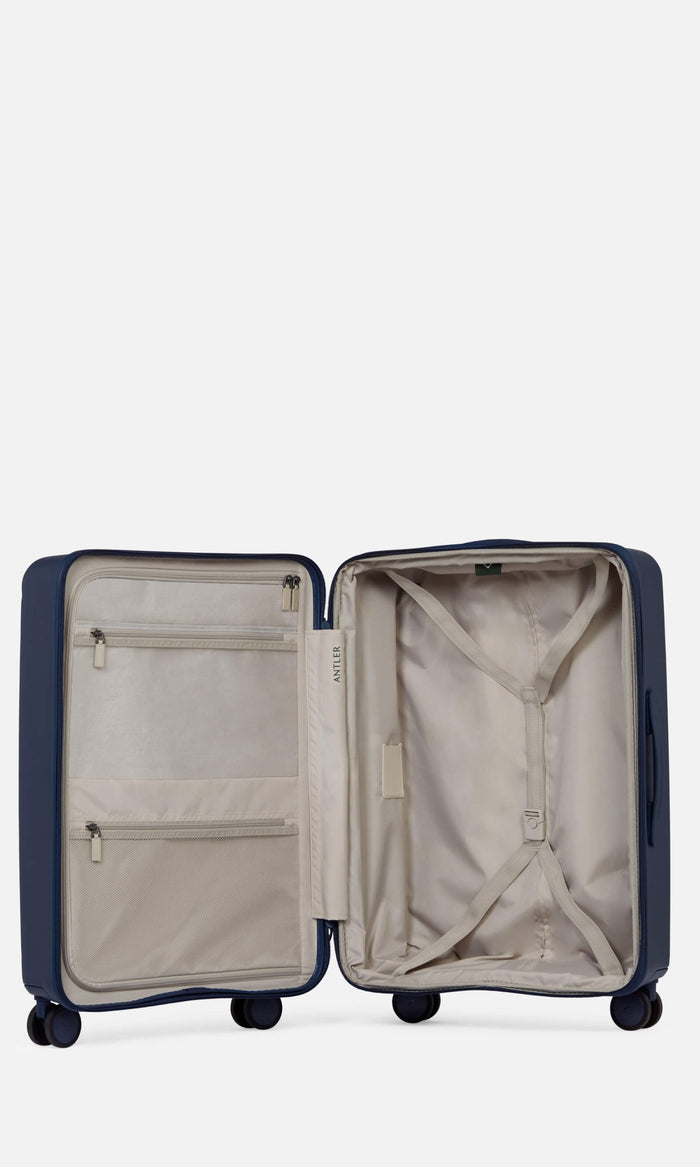 a blue suitcase with zippers and pockets