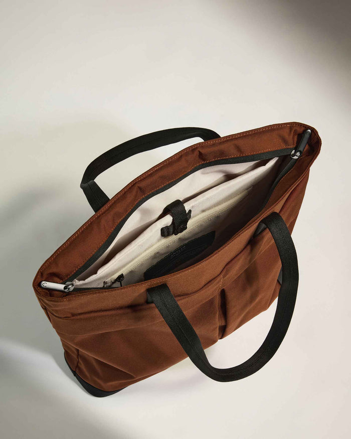 a brown bag with black handles